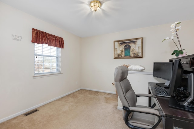 carpeted home office featuring visible vents and baseboards