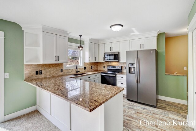kitchen with open shelves, a sink, stainless steel appliances, a peninsula, and tasteful backsplash