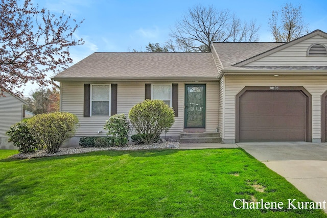 view of front of property featuring an attached garage, roof with shingles, a front yard, and concrete driveway