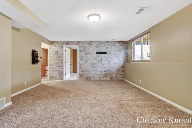 carpeted empty room featuring baseboards and visible vents
