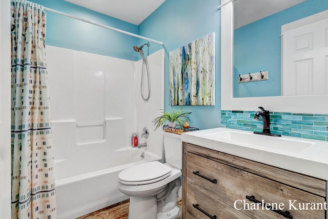 full bathroom featuring tasteful backsplash, wood finished floors, vanity, toilet, and shower / bath combo with shower curtain