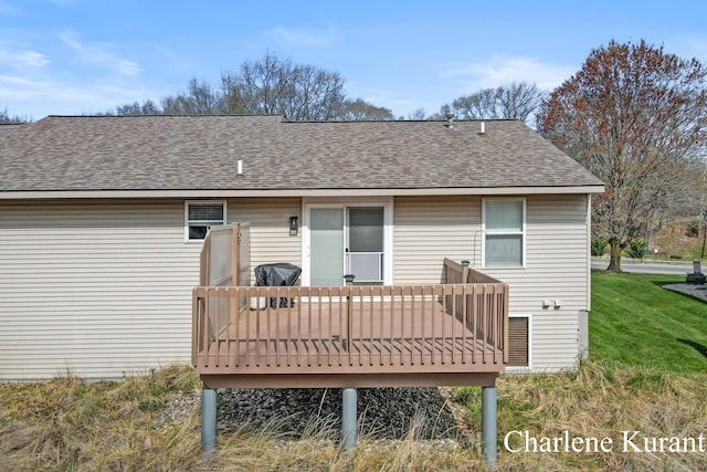 back of house featuring a shingled roof and a wooden deck