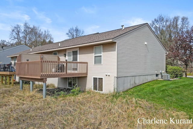 back of house featuring a shingled roof, central air condition unit, a yard, and a deck