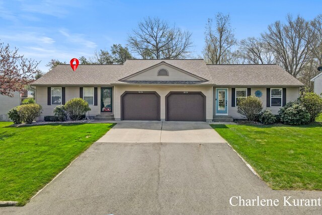 single story home featuring an attached garage, a shingled roof, a front lawn, and driveway