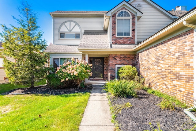 6360 Robison Ln, Saline, MI 48176 - traditional-style home with brick siding, a shingled roof, and a front yard