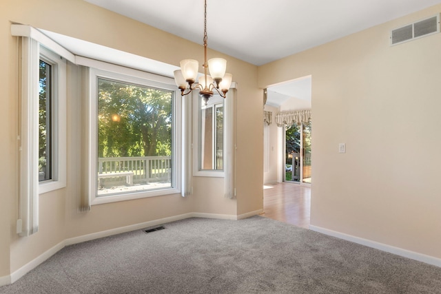 6360 Robison Ln, Saline, MI 48176 - unfurnished room featuring carpet flooring, baseboards, visible vents, and an inviting chandelier