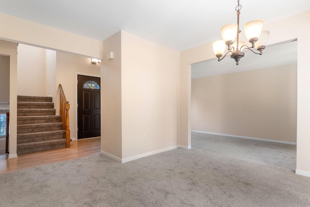6360 Robison Ln, Saline, MI 48176 - carpeted empty room featuring baseboards, stairs, and a notable chandelier