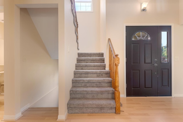 6360 Robison Ln, Saline, MI 48176 - foyer featuring stairs, baseboards, and wood finished floors