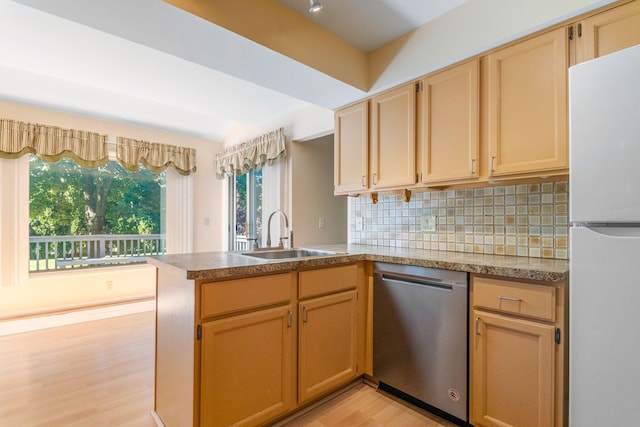 6360 Robison Ln, Saline, MI 48176 - kitchen featuring light wood-type flooring, dishwasher, a sink, freestanding refrigerator, and a peninsula