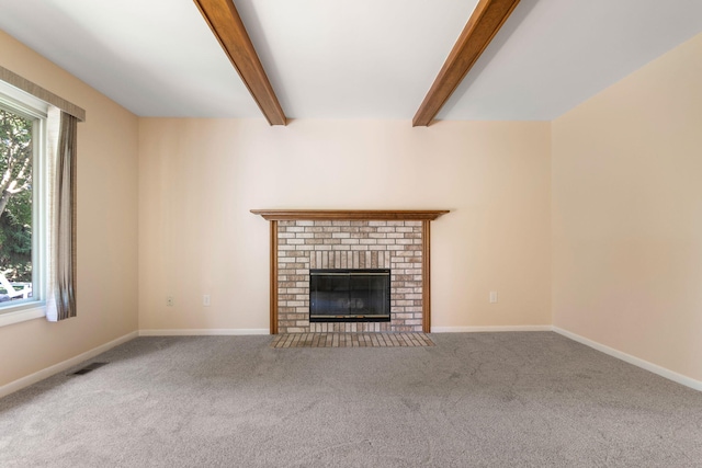 6360 Robison Ln, Saline, MI 48176 - unfurnished living room featuring a brick fireplace, visible vents, beam ceiling, and carpet