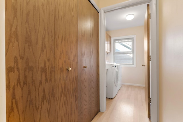 6360 Robison Ln, Saline, MI 48176 - laundry room with baseboards, laundry area, light wood-type flooring, and washing machine and clothes dryer
