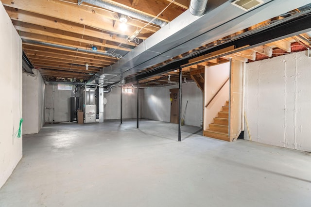 6360 Robison Ln, Saline, MI 48176 - unfinished below grade area featuring heating unit and stairway