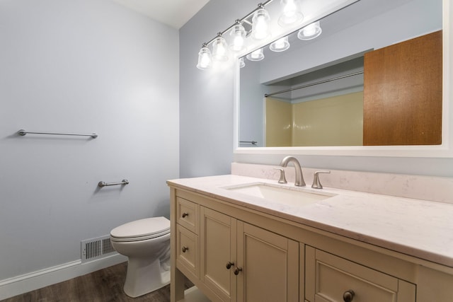 6360 Robison Ln, Saline, MI 48176 - bathroom with visible vents, vanity, wood finished floors, toilet, and baseboards