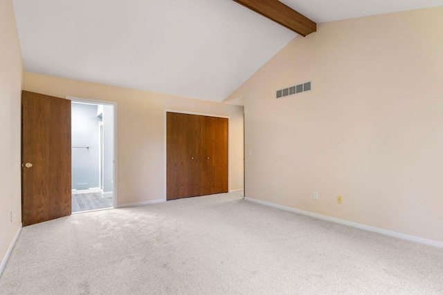 6360 Robison Ln, Saline, MI 48176 - unfurnished bedroom featuring visible vents, a closet, vaulted ceiling with beams, ensuite bathroom, and carpet