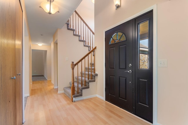 6360 Robison Ln, Saline, MI 48176 - entryway with baseboards, light wood-style flooring, and stairway
