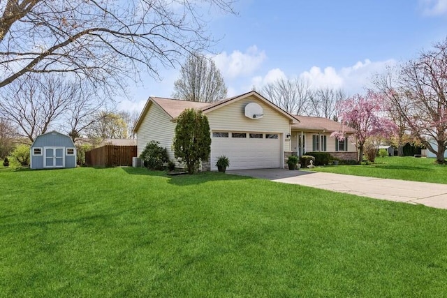 3833 Green Acre Dr, Saint Joseph, MI 49085 - view of front of house featuring a front yard, a storage shed, a garage, an outdoor structure, and concrete driveway