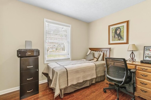 3833 Green Acre Dr, Saint Joseph, MI 49085 - bedroom featuring dark wood-style flooring, baseboards, and a textured ceiling
