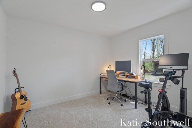 carpeted home office featuring baseboards