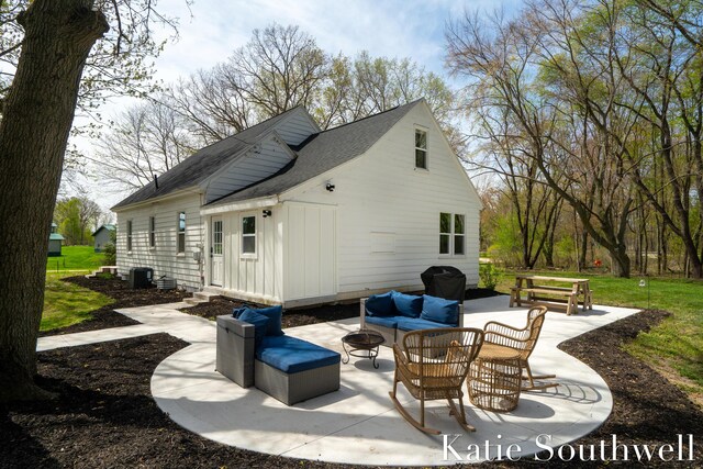 view of patio / terrace with an outdoor living space with a fire pit and cooling unit