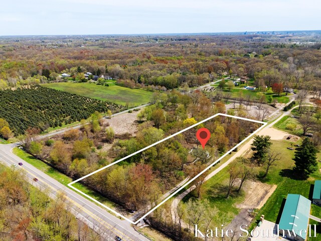 drone / aerial view with a wooded view
