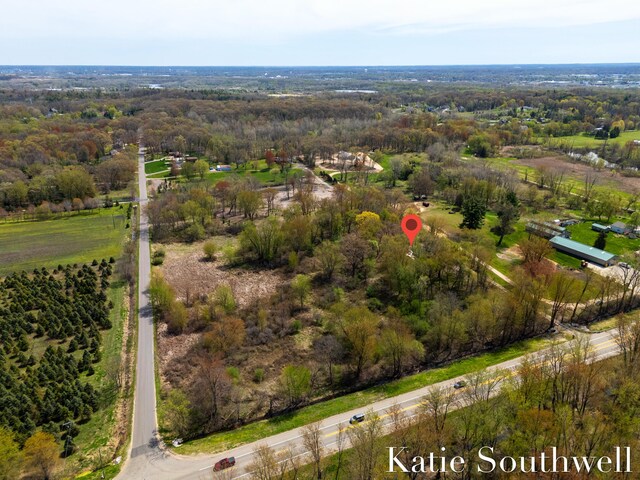 drone / aerial view featuring a view of trees