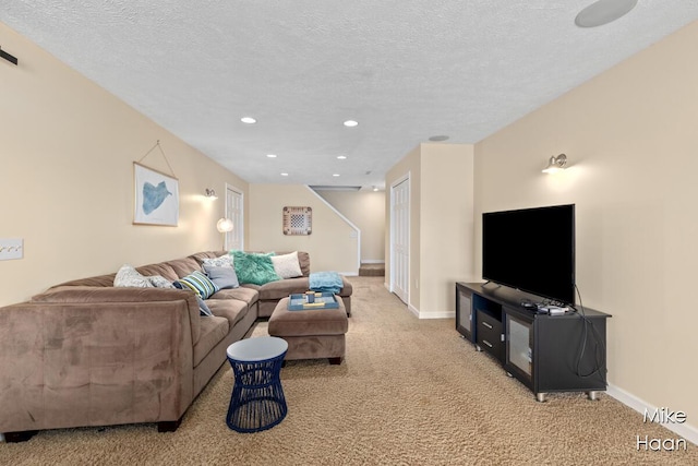 carpeted living area with recessed lighting, a textured ceiling, and baseboards