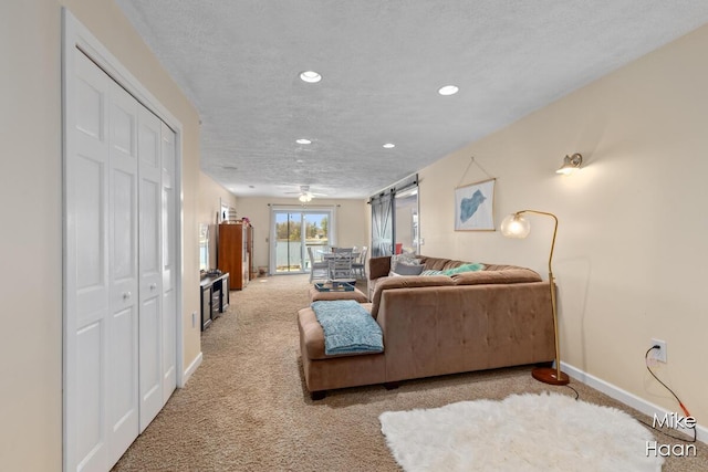 living area with baseboards, ceiling fan, carpet flooring, and recessed lighting