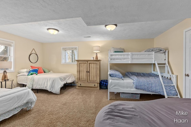 carpeted bedroom featuring a textured ceiling