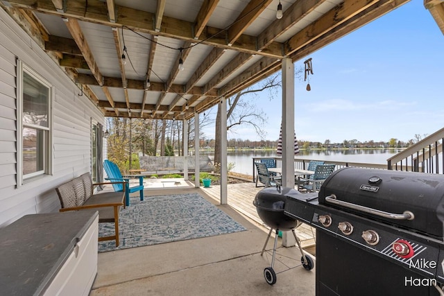 view of patio / terrace featuring grilling area and a water view
