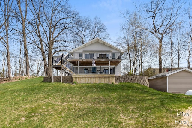 rear view of property with brick siding, a yard, a deck, and stairway