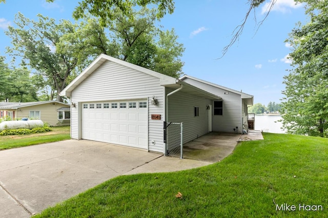 13545 Armitage Dr, Coral, MI 49322 - view of property exterior featuring an attached garage and a yard