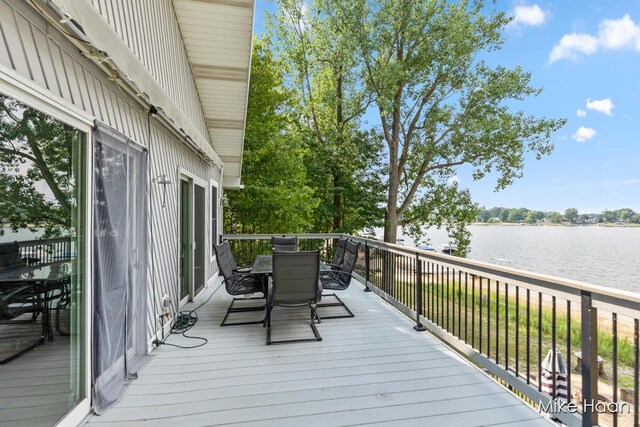 13545 Armitage Dr, Coral, MI 49322 - deck with outdoor dining area and a water view