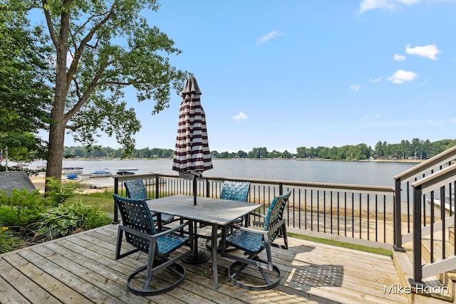 13545 Armitage Dr, Coral, MI 49322 - deck with outdoor dining space and a water view