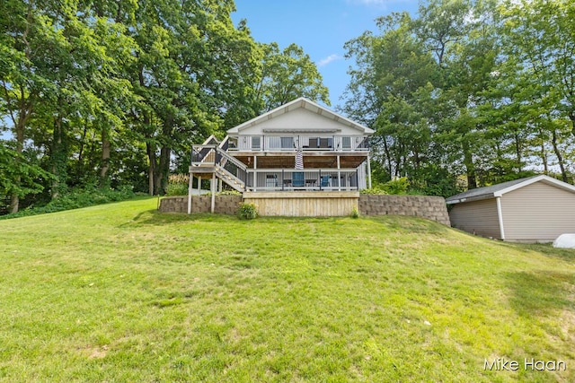 13545 Armitage Dr, Coral, MI 49322 - rear view of property with a wooden deck, stairway, and a lawn