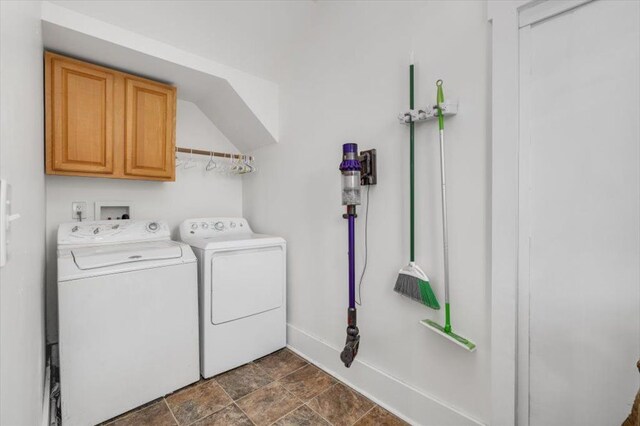 washroom with separate washer and dryer, cabinet space, baseboards, and stone finish floor