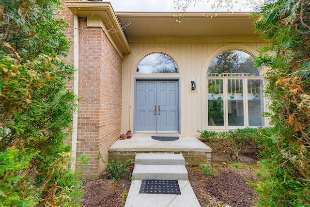 entrance to property featuring brick siding