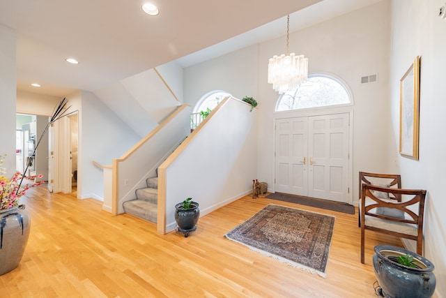 foyer featuring visible vents, recessed lighting, wood finished floors, and a healthy amount of sunlight
