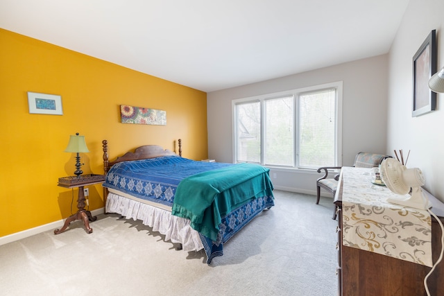 carpeted bedroom featuring baseboards