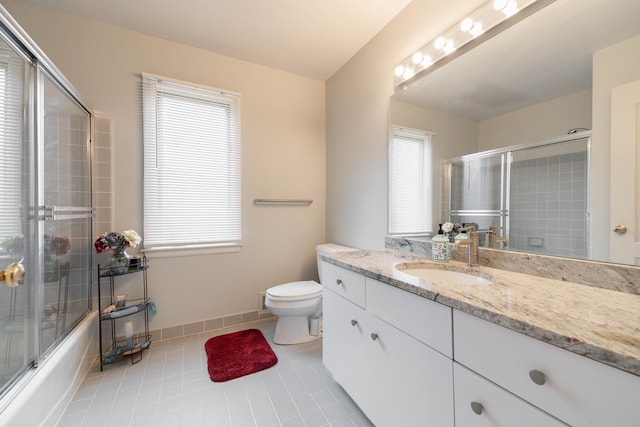 full bath with vanity, enclosed tub / shower combo, tile patterned floors, and toilet