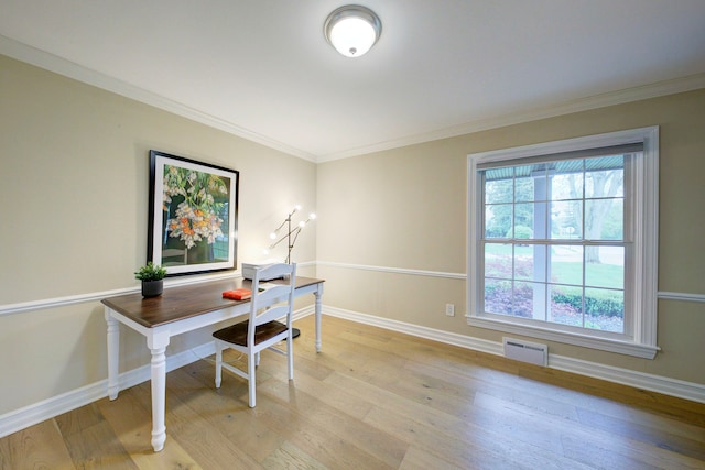 office space featuring baseboards, light wood finished floors, and visible vents