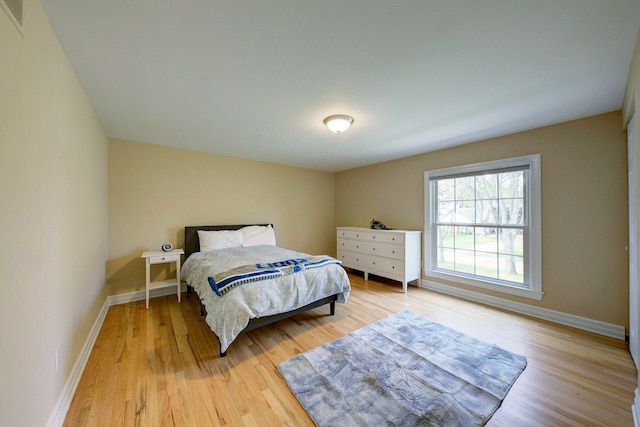 bedroom featuring baseboards and light wood-style floors