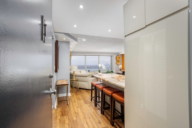 hallway featuring recessed lighting and light wood-style flooring