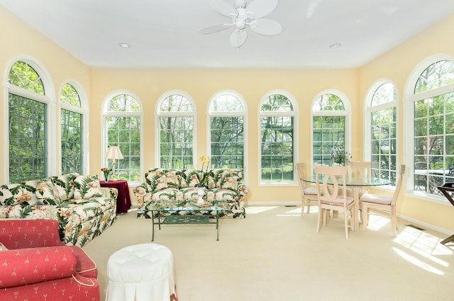 sunroom / solarium featuring a healthy amount of sunlight, carpet, and french doors