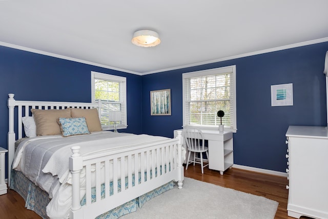 bedroom with baseboards, ornamental molding, and wood finished floors