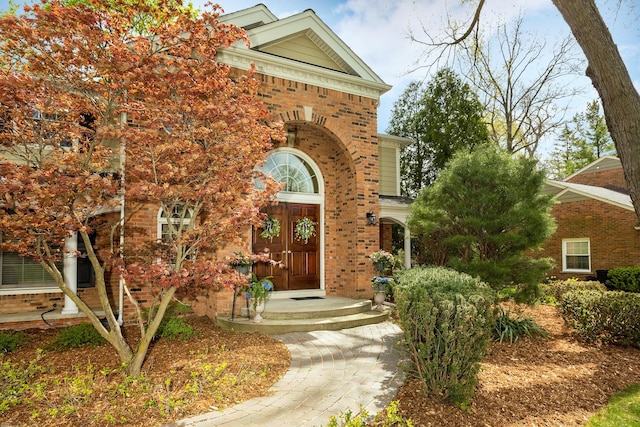 doorway to property featuring brick siding