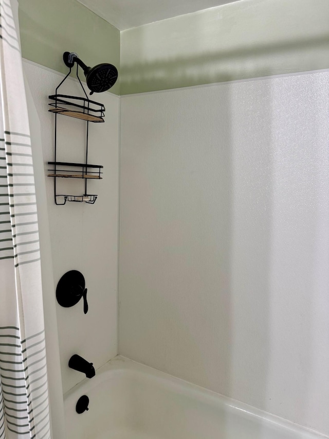 bathroom with shower / bath combo with shower curtain