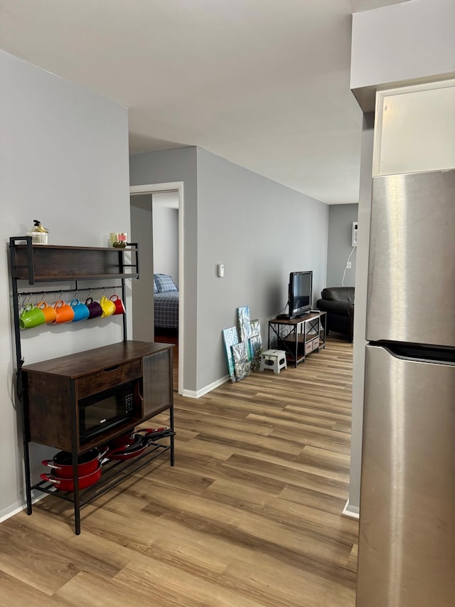 dining area featuring light wood-style floors and baseboards