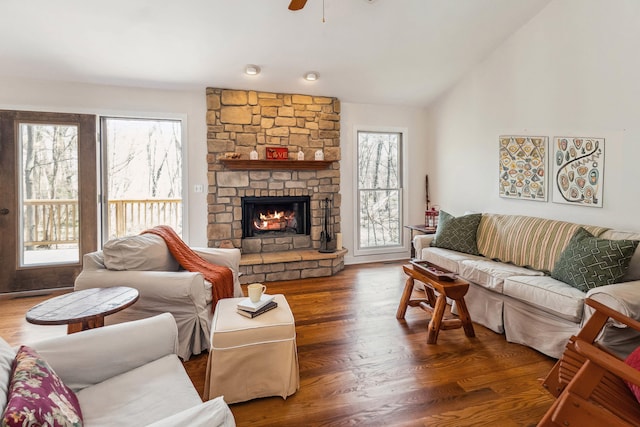living area featuring a healthy amount of sunlight, ceiling fan, and a fireplace