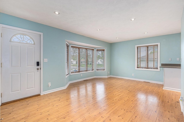 entryway featuring recessed lighting, baseboards, and light wood-style flooring