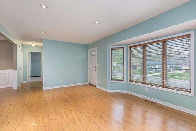 unfurnished room with visible vents, recessed lighting, baseboards, and light wood-type flooring